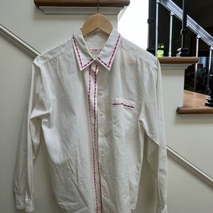 100% cotton fuchsia embroidery details. Button up back pleat details.